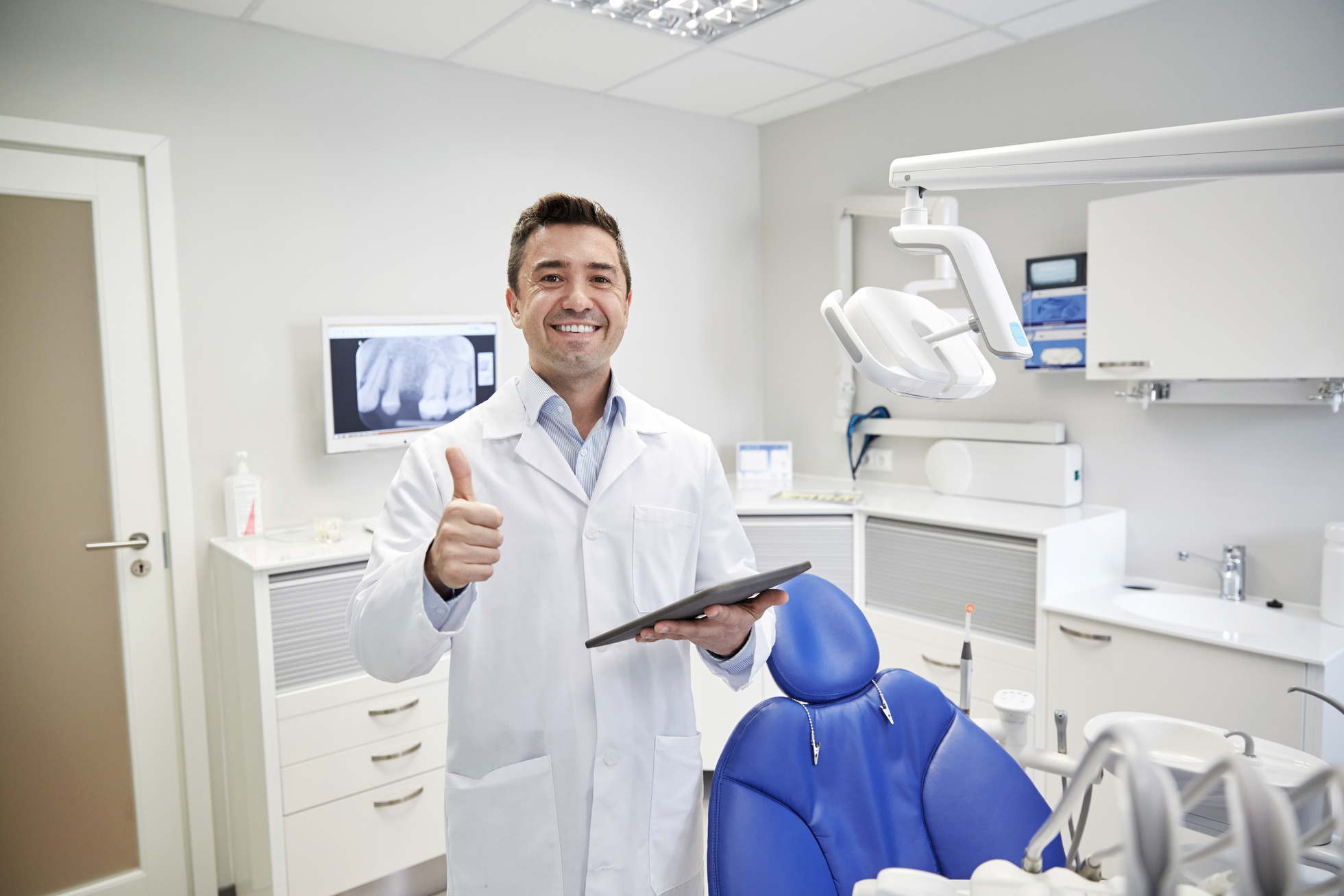 Happy Dentist Showing Thumbs up with Tablet Pc
