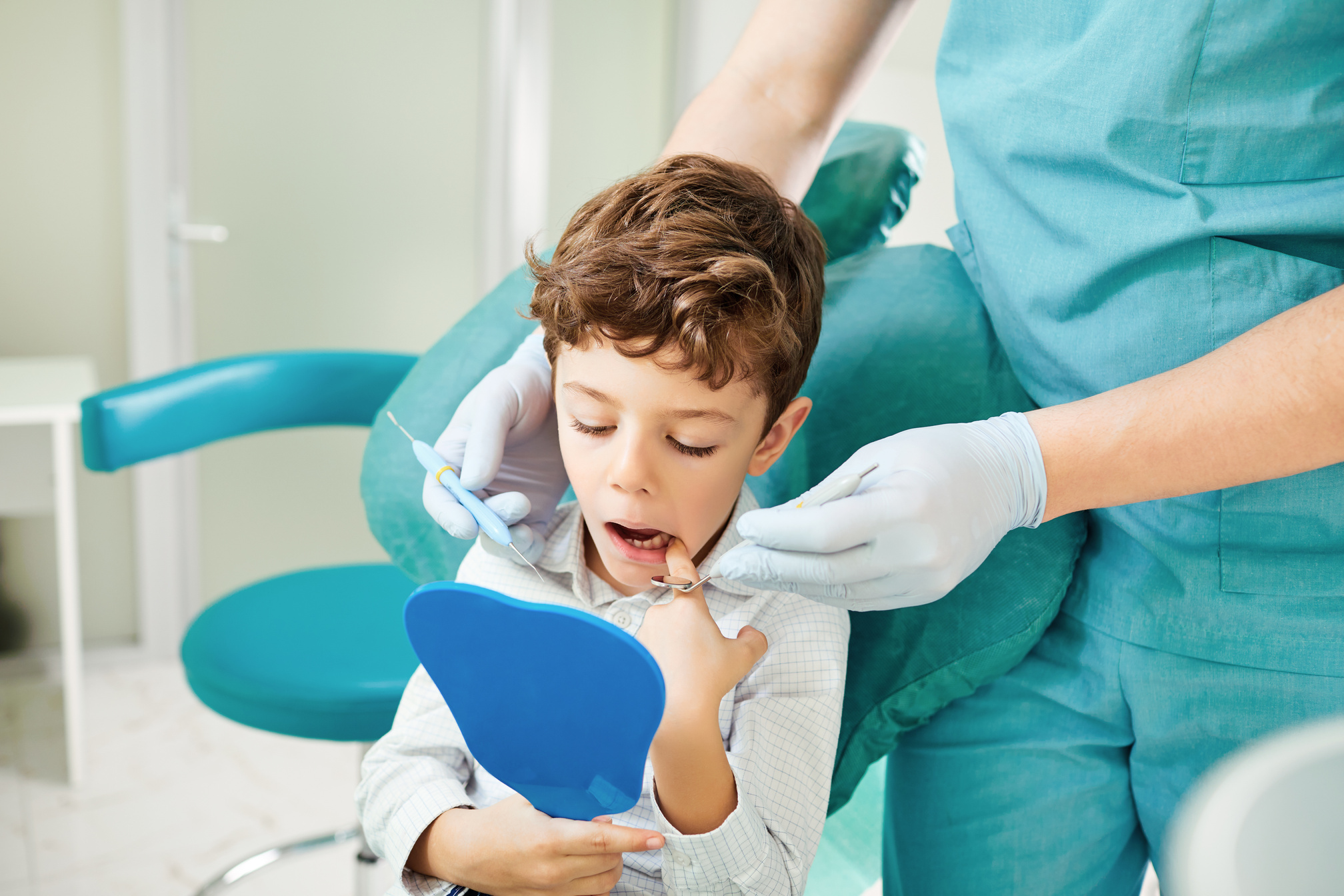 Child and Dentist Checking Teeth 