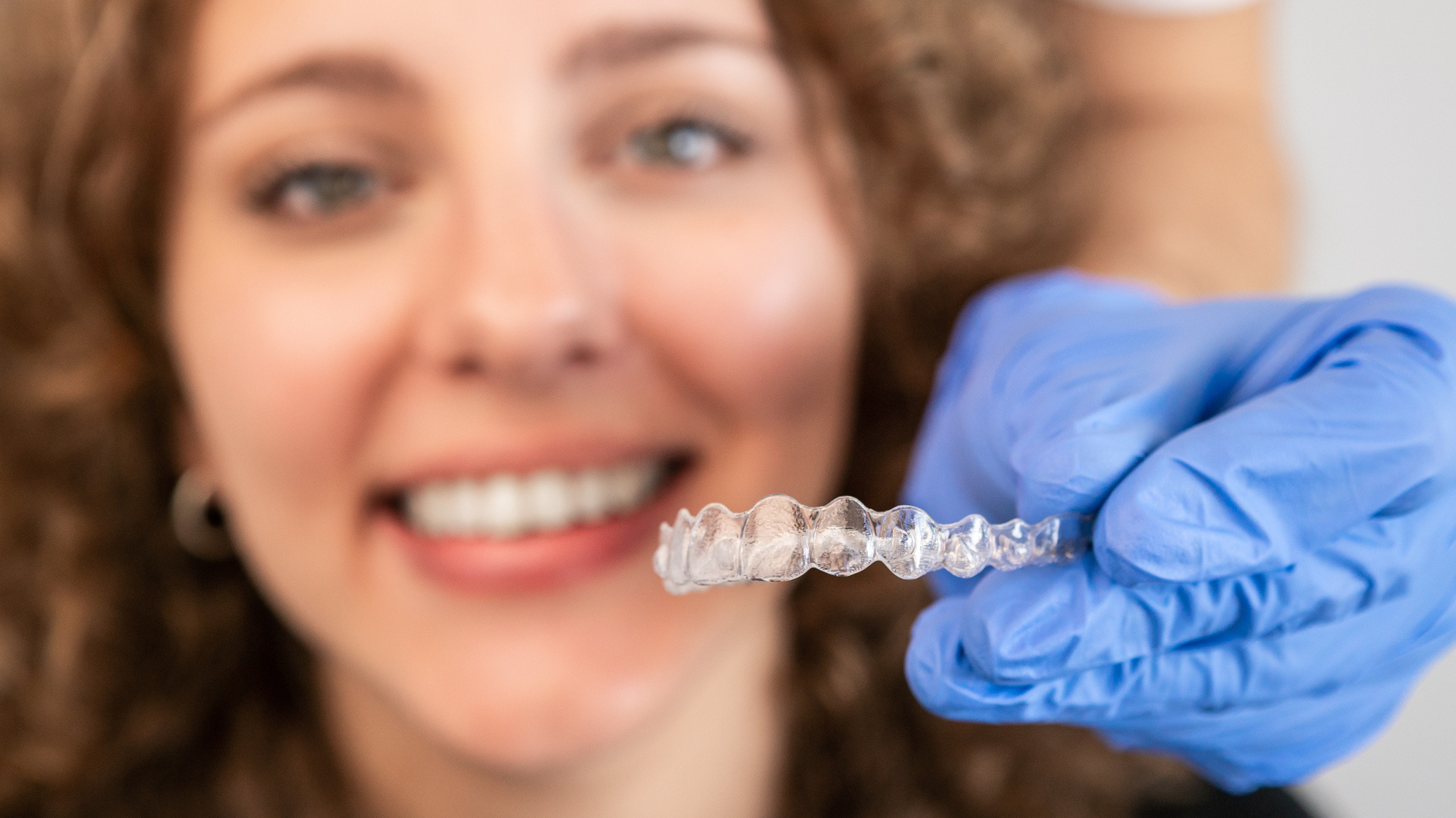 Orthodontic Specialist Adjusting and Placing Invisible Aligners on Woman