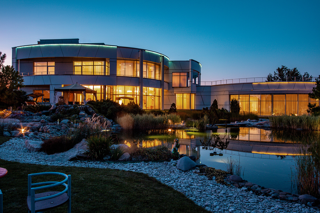 Stylish Country House with Well-Groomed Adjacent Territory with Artificial Pond in Summer Twilight